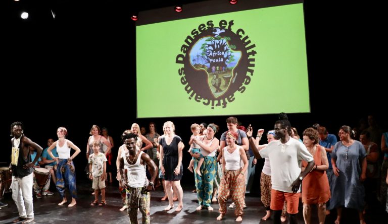 Photo représentant une performance de danse africaine impliquant danseurs et spectateurs
